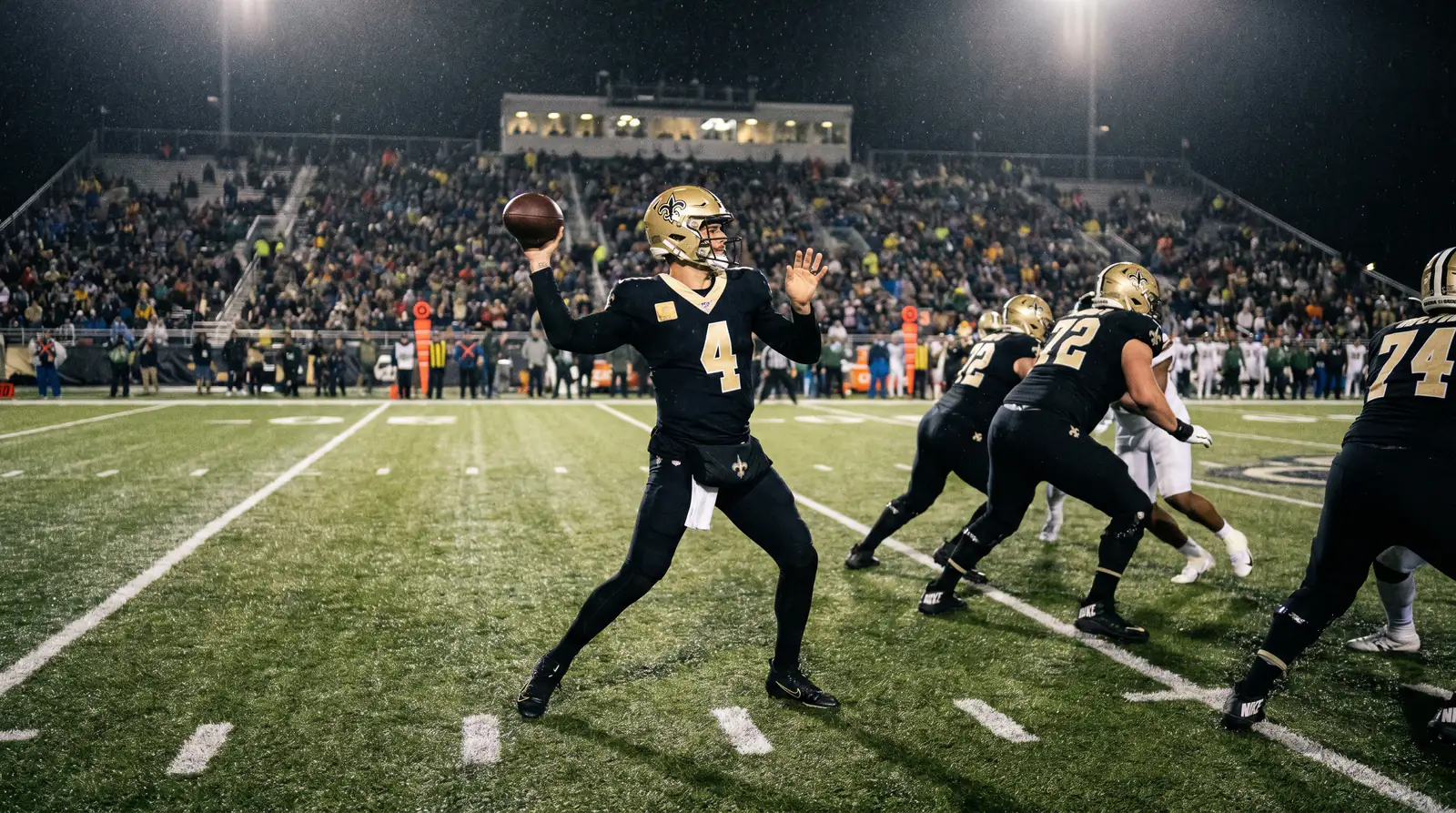 NFL quarterback dropping back to pass under floodlights as the MVP frontrunner