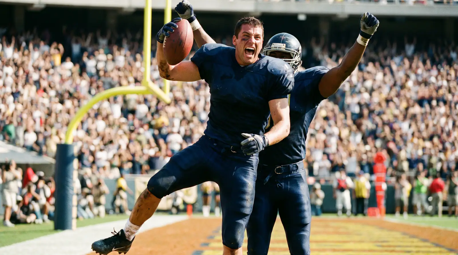 American football receiver celebrating a touchdown in the end zone with teammates