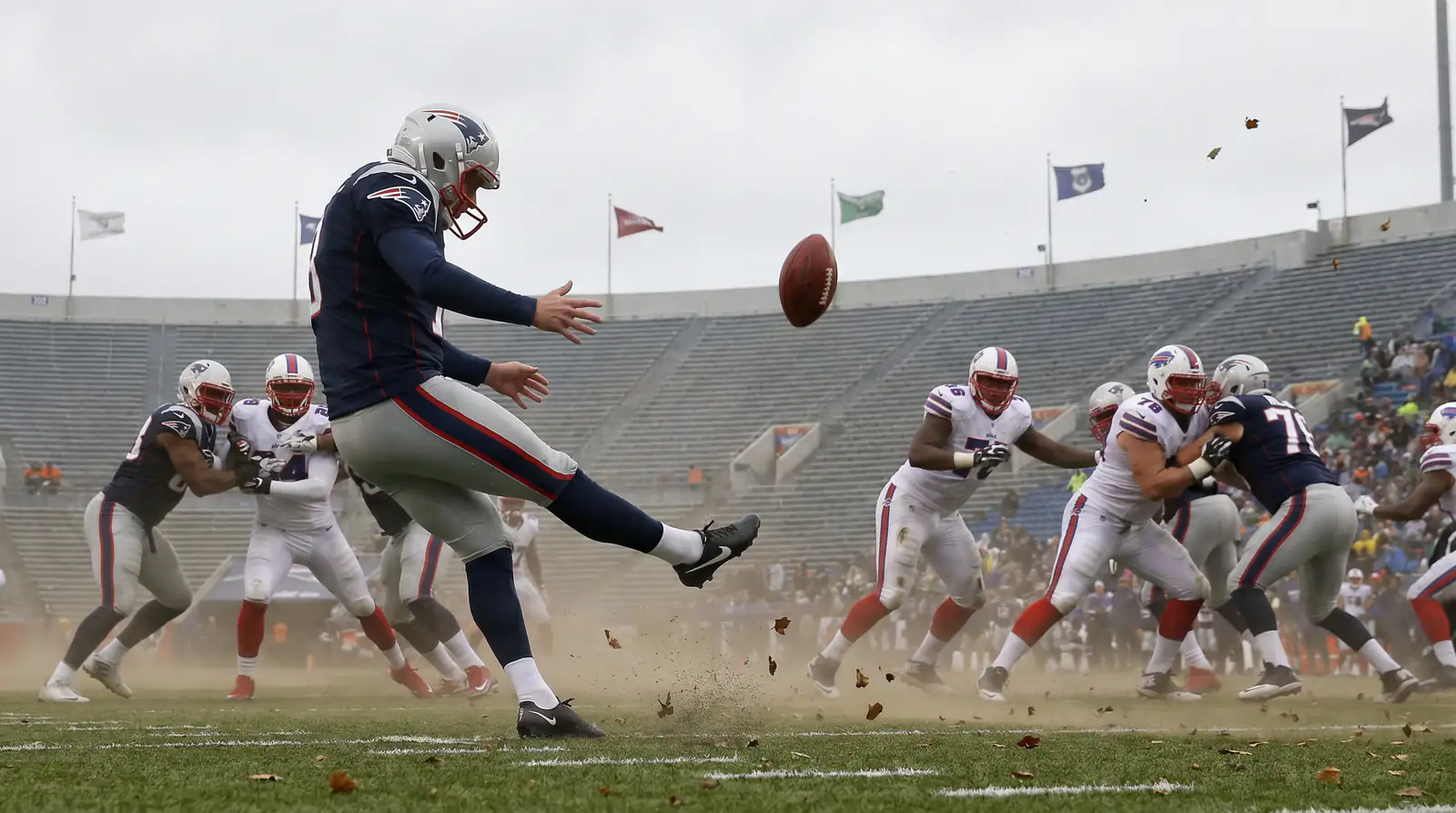 NFL game played in strong wind with the ball wobbling on a kick